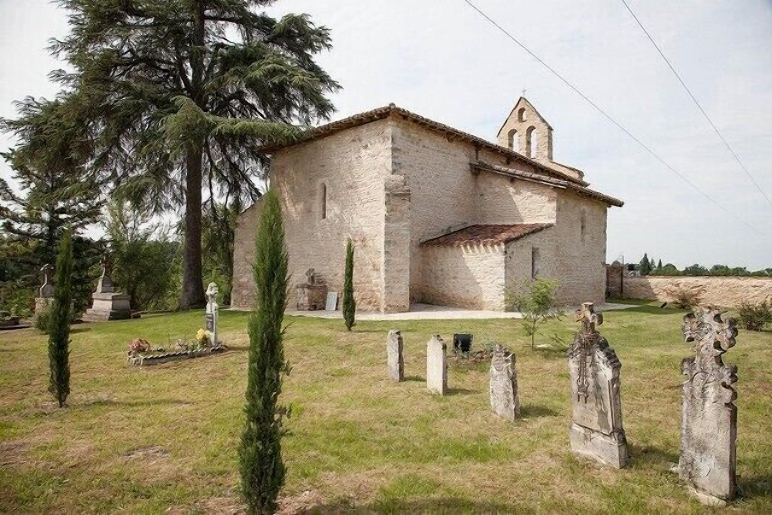 A stone church with a bell tower, surrounded by a cemetery with gravestones.