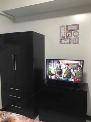 Enjoy a homey atmosphere with a flat-screen TV and a stylish entertainment unit.
