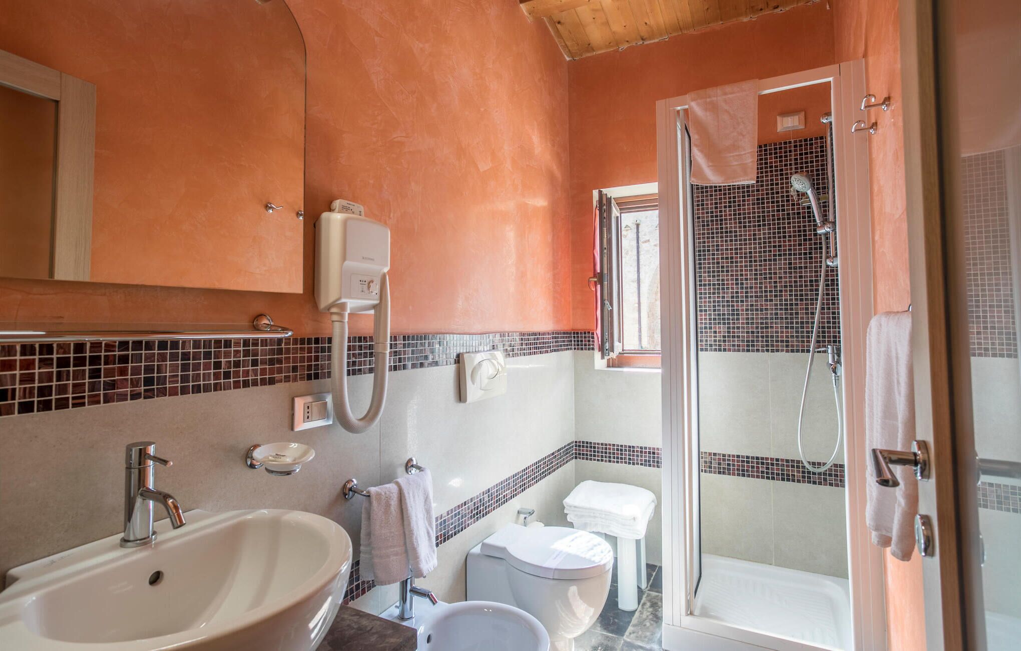 Ein Badezimmer mit Waschbecken, Toilette und Duschbereich.