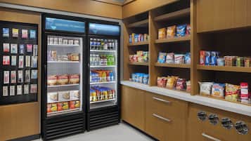 A snack and beverage area with refrigerated cases and shelves stocked with various snacks and drinks.