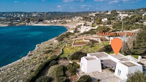 An aerial view of a coastal area with white buildings, a clear blue sea, and a marker indicating a location. - Wonderful seaview w/ direct sea access & jacuzzi (Leuca)