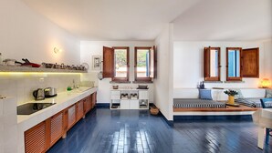 A compact kitchen with a central island, wooden cabinets, and a built-in sink. - Direct sea access and stunning location (Leuca)