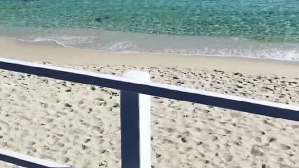 A beach with clear turquoise water, a sandy shore, and a rocky outcrop in the distance. - Stunning House Between the Countryside and the Sea - Southern Sardinia CIN: IT111070C2000U0960 (Porto Pino (Sardegna))