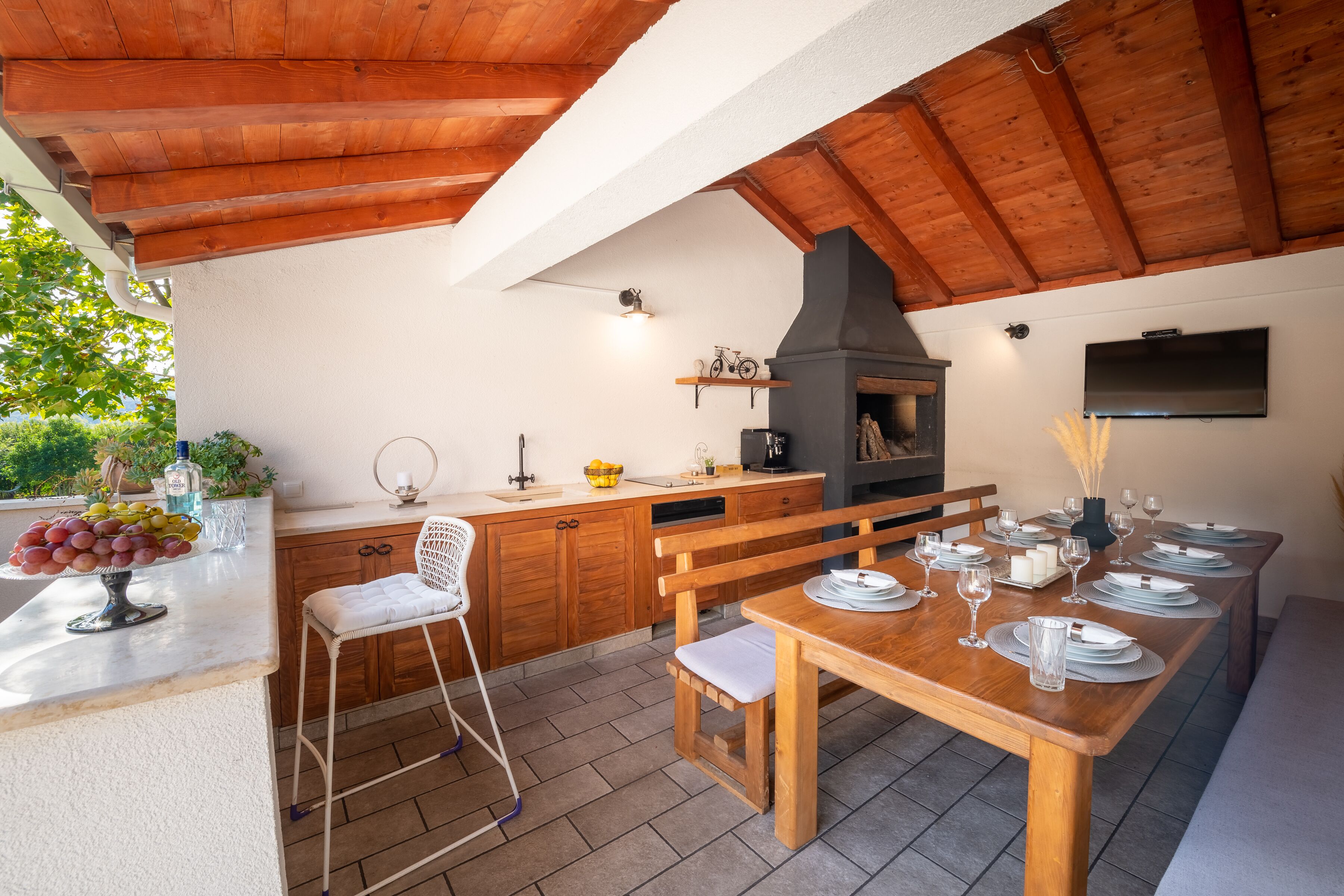 A spacious kitchen with wooden cabinets, a built-in oven, and a dining area set for six.