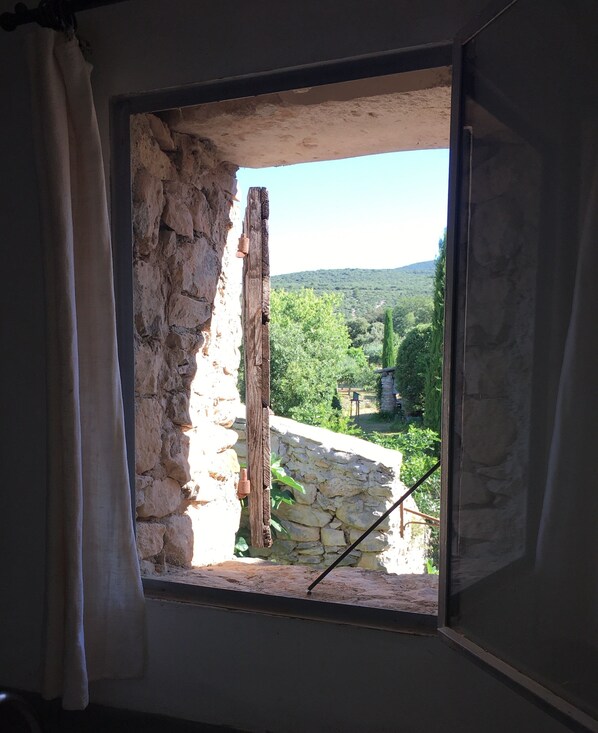 A rustic room with a stone wall and a window. - La Grande Figuière des Viaux (Rustrel)