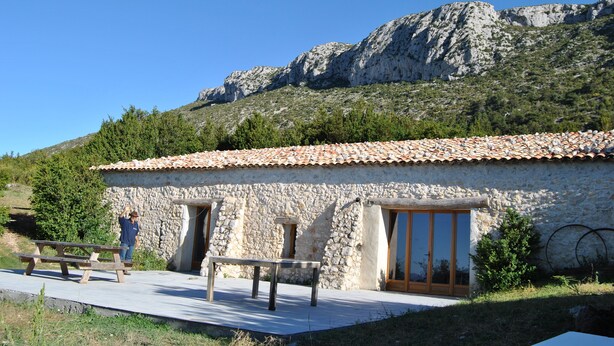 A stone building with a tiled roof, wooden door, and windows. - SMALL GITE "BERGERIE" (Bargeme)