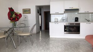 A modern kitchen with white cabinets, stainless steel appliances, and a tiled backsplash. - Split-Dalmatia-Most beautiful sea view on Adriatic,beach on the sea,heated  pool (Splitsko-dalmatinska županija)