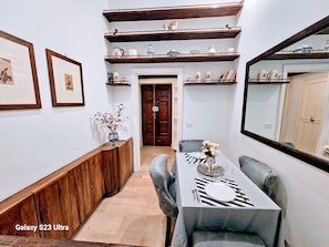 Enjoy meals in a stylish dining area with a long bench, framed pictures, and a beautifully set table.