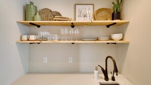 A kitchen with two wooden shelves, a sink, and a faucet. - Casa Grosgrain-Gorgeous views, On-Site winery (Walla Walla)