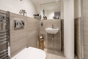 A modern bathroom with a toilet, sink, and towel rack. - Cocoa Suites 37 - York city centre 1 bed apartment with sofa bed (sleeps 3) (York)
