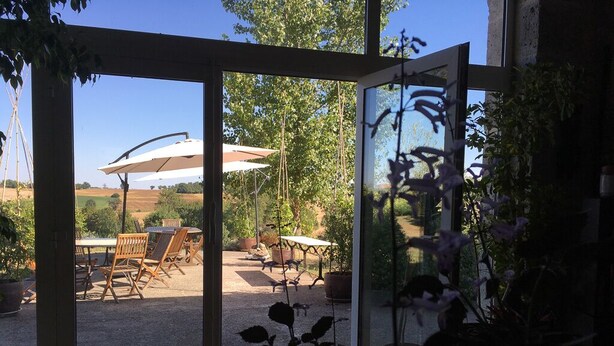 A patio area with outdoor furniture and a view of the countryside. - Welcome to our house, we are happy to open its doors to you! (Calignac)