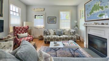 Smart TV, lareira, livros, aparelho de som