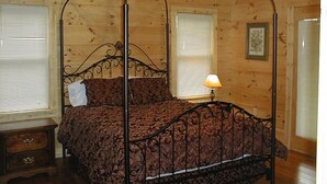 A wooden-paneled bedroom with a four-poster bed, a nightstand, and a ceiling fan. - Townsend, Tn & Smoky Mountains! Wooded Privacy & Sleeps 15 (Townsend)