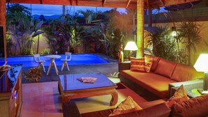 An outdoor lounge area with a pool, seating, and tropical plants. - Private Villa with Swimming pool, jetted Plunge Pool and Free Transfers (Koh Samui)