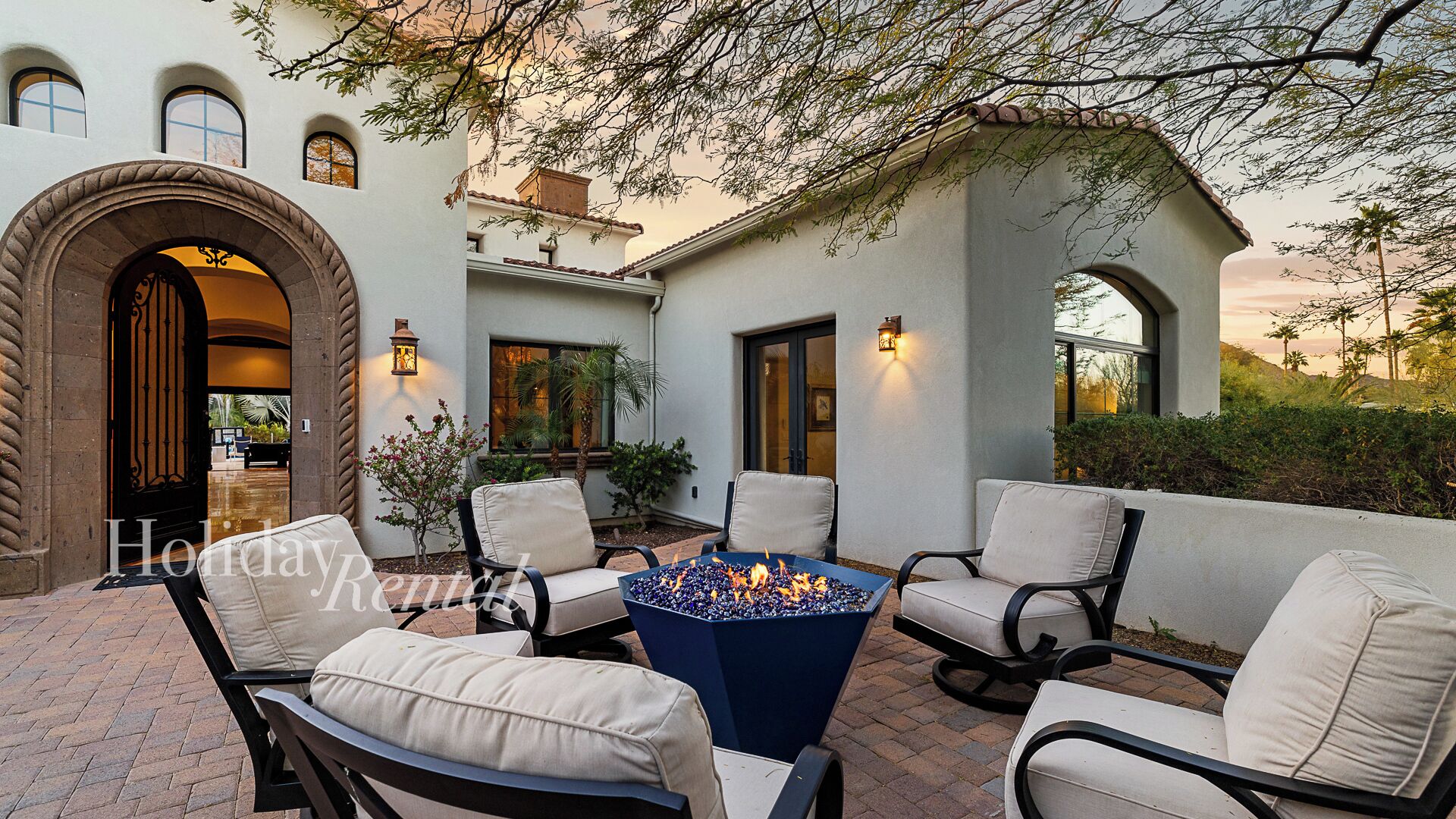 A patio area with outdoor seating and a fire pit.