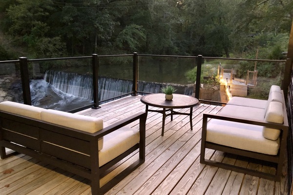 Glass Railing Deck over waterfall with restoration hardware furniture