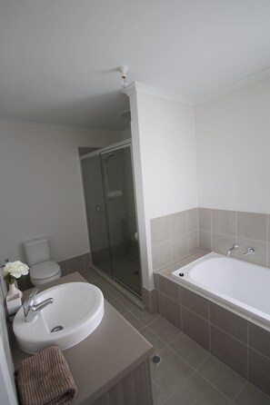 Shower, hair dryer, towels, toilet paper