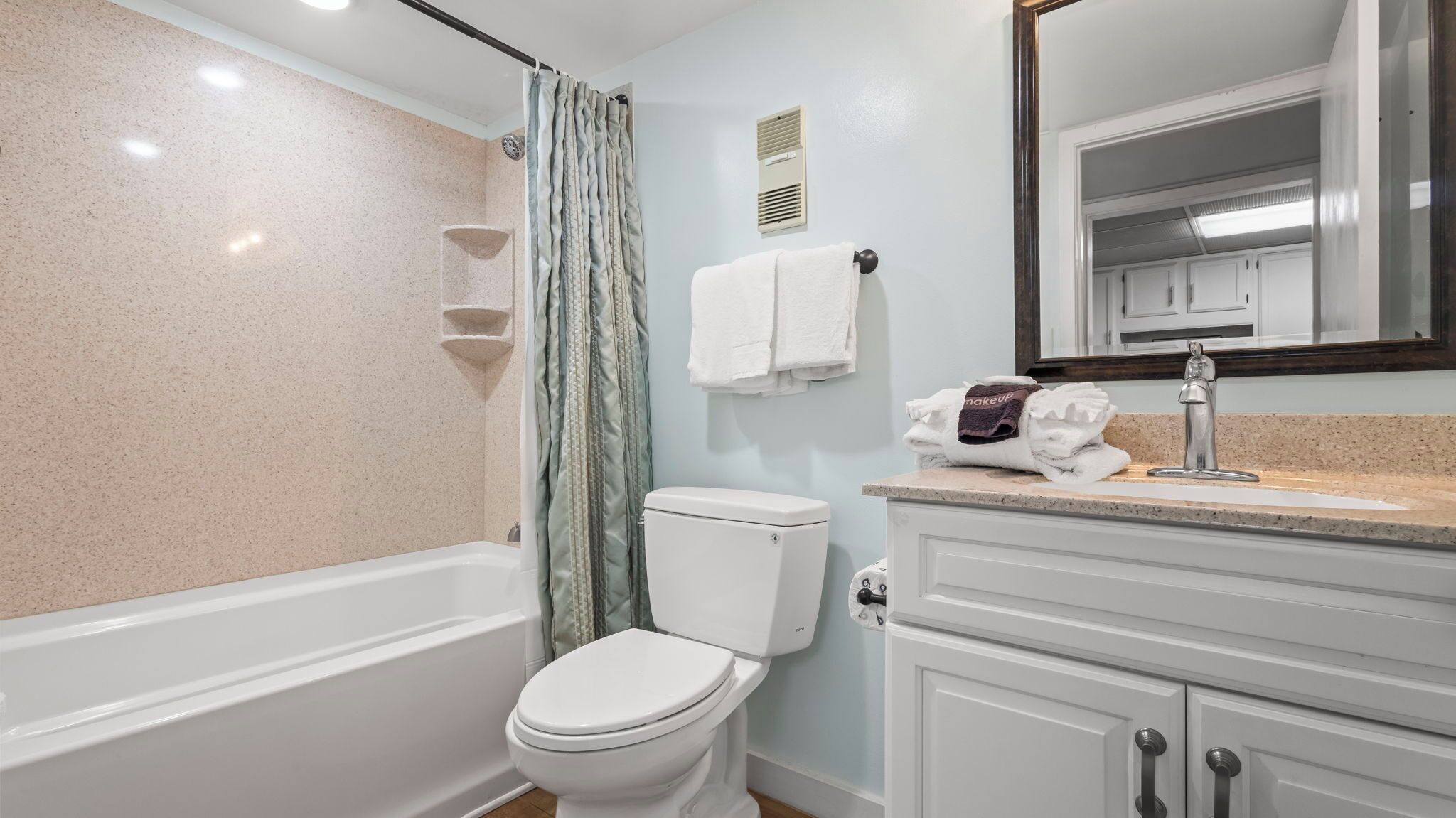 A bathroom with a bathtub, toilet, and sink.