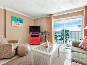 Relax in style with a flat-screen TV, comfortable seating, and a balcony overlooking the ocean.
