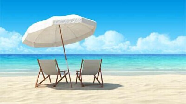 A beach scene with two beach chairs and a white umbrella.