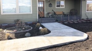 A house with a front porch, a small garden, and a bench. - Vacation and Business Get-A-Way/Lay-Over (John Day)