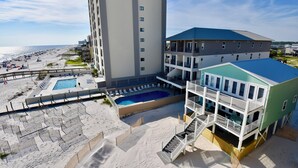 A hotel with a pool, beach access, and a view of the ocean. - Beachfront condo with multiple beach views (Gulf Shores)