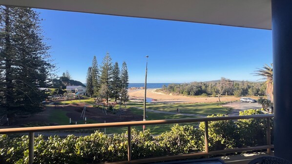 A balcony with a view of a golf course, trees, and a clear blue sky. - POINT BRINER 4 - MAIN BEACH VIEWS, SINGLE LOCK UP GARAGE (South West Rocks)