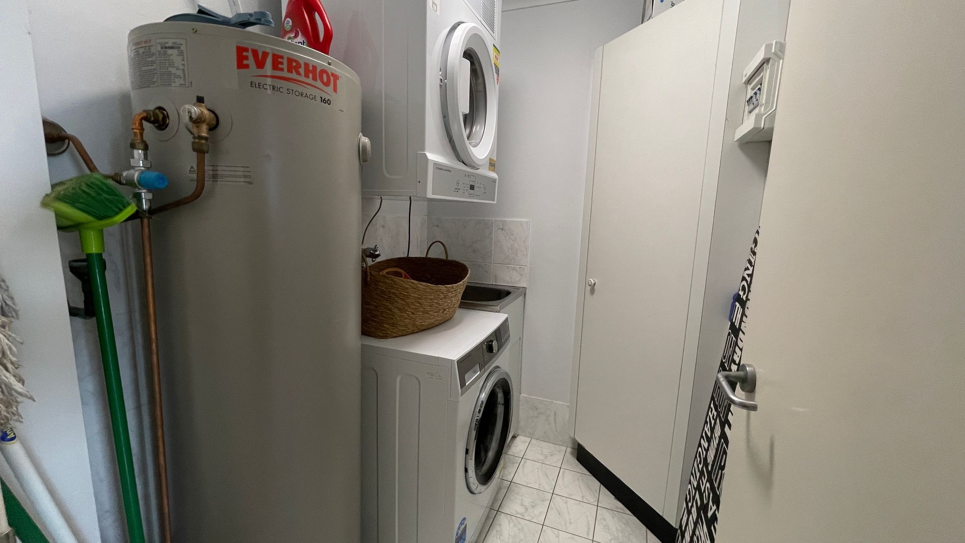 A laundry room with an electric storage unit, a washing machine, and a dryer.