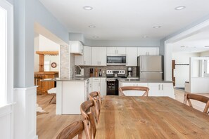 Enjoy cooking in this well-lit kitchen with a central island and stove, microwave, and dining area.