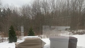 A covered outdoor object, possibly a pool or hot tub, in a snowy environment with footprints in the snow. - Ski Mountain Chalet w/ Hot tub, Fireplace, Game Room -Windham Mountain (Hensonville)