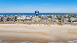 A coastal residential area with beachfront houses and a clear view of the ocean. - Oceanfront Home w/ Private Pool, Hot Tub, Elevator, Game Room, Home Theater (Frisco)