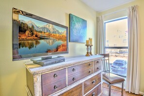 Enjoy a scenic view from the comfort of your room, featuring a large flat-screen TV and a dresser with ample storage.