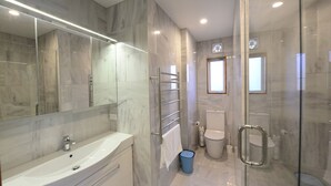 A modern bathroom with a glass-enclosed shower, a large mirror, and a white sink. - Cockle Lane Beach Studio Two - a beachside getaway, just for you (Waimairi Beach)
