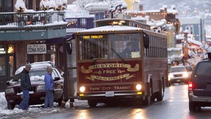 A historic free trolley on a snowy street.