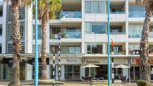 A modern building with multiple floors, featuring a Babette restaurant on the ground floor. - Awesome Downtown Location - Park & Walk (Tauranga)