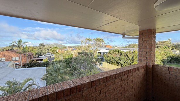 A balcony with a view of residential buildings and trees. - WOODY WONDER UNIT 8 - TOP FLOOR GREAT LOCATION (SOUTH WEST ROCKS)