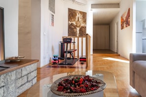 Relax in a spacious living area with a fitness zone, kitchenette, and artistic touches.