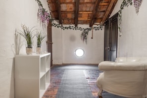 Relax in a space with a comfortable armchair and lush greenery.
