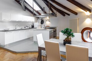Enjoy cooking in this kitchen with a central island, stove, sink, and microwave.