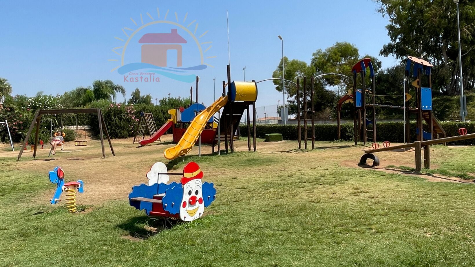 A playground with various play structures including slides and swings.