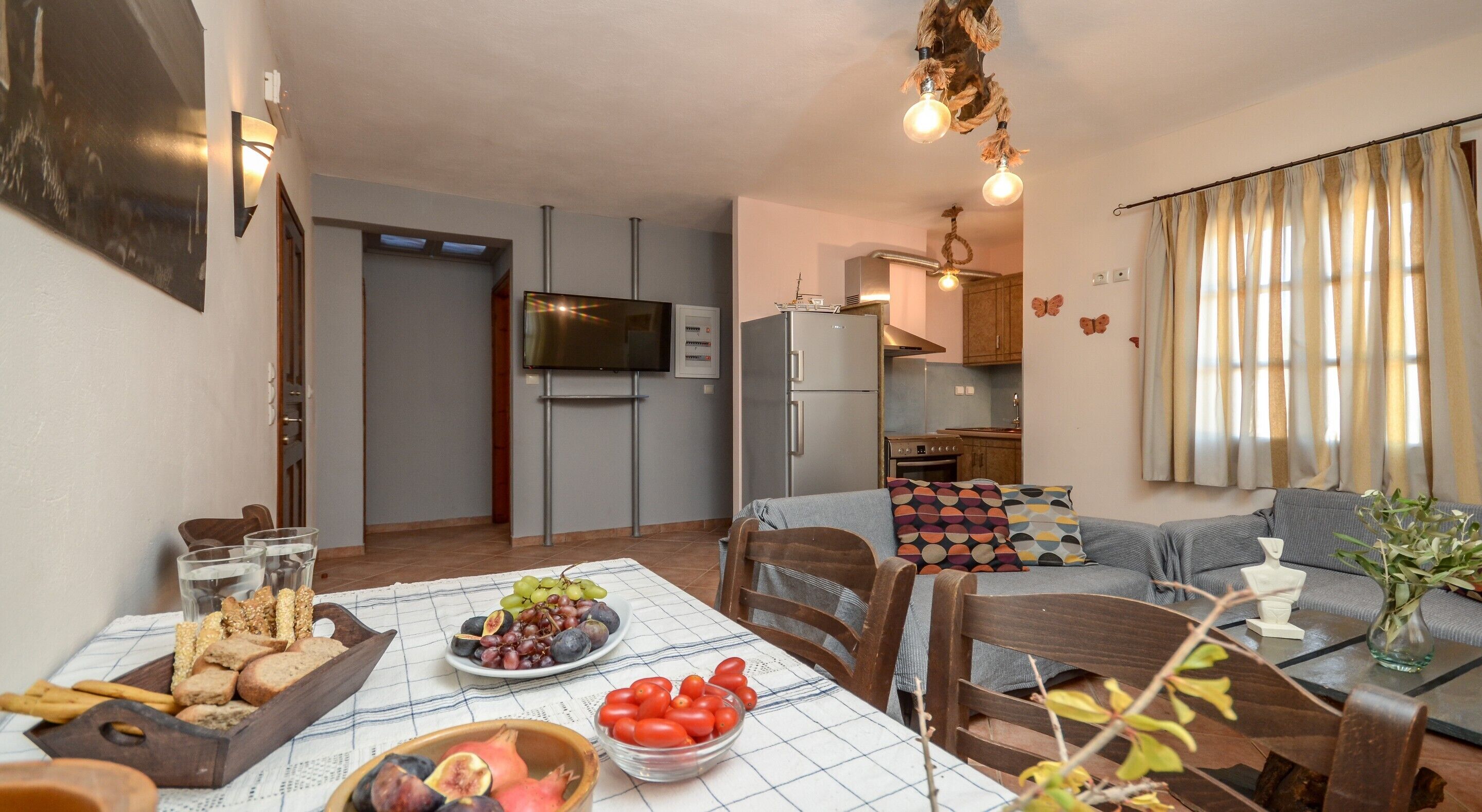 A compact living space with a dining area, kitchenette, and seating area.