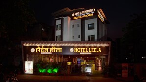 Hotel Leela with a sign indicating Deluxe A/C rooms and a multi-cuisine, wine & dine option. - Hotel Leela (Kalyan)