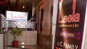 A restaurant entrance with a sign indicating the A/C family section is now open. - Hotel Leela (Kalyan)