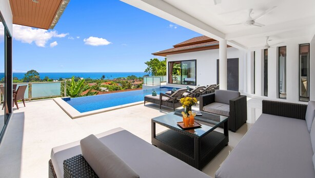 A modern outdoor living area with a pool, seating, and a view of the ocean. - Sunny Banks - 4 Bed Private Pool Sea View Villa (Ko Samui)