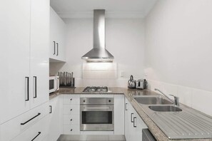 Fridge, microwave, oven, stovetop - Official Lakes Resort One Bedroom Apartments (Cairns North)