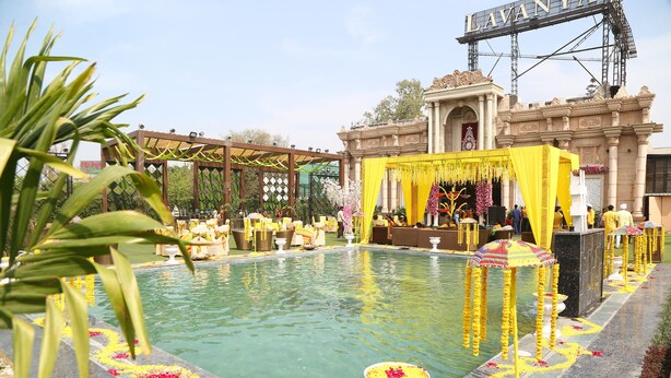 A pool area with yellow decorations and a building in the background.