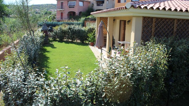 A residential property with a well-maintained lawn, a patio with outdoor furniture, and a view of neighboring houses. - SHORT TERM LET IN SARDINIA, HOLIDAY HOME OLBIA-PITTULONGU WITHIN 5MIN FROM BEACH (Olbia)