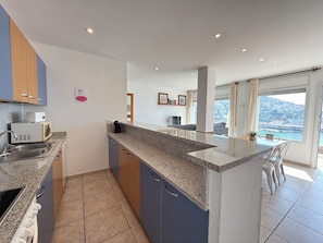 A modern kitchen with granite countertops, a built-in microwave, and a sink. - Agi Rodas Bajo 1 Apartamento for rent in Roses Girona. (Roses)
