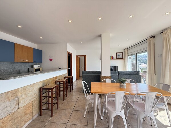 A modern kitchen with granite countertops, wooden cabinets, and a built-in microwave.
