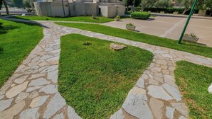 A stone pathway leading to a building with a mountainous backdrop. - Agi Rescator 214 Apartamento for rent in Roses Girona. (Roses)
